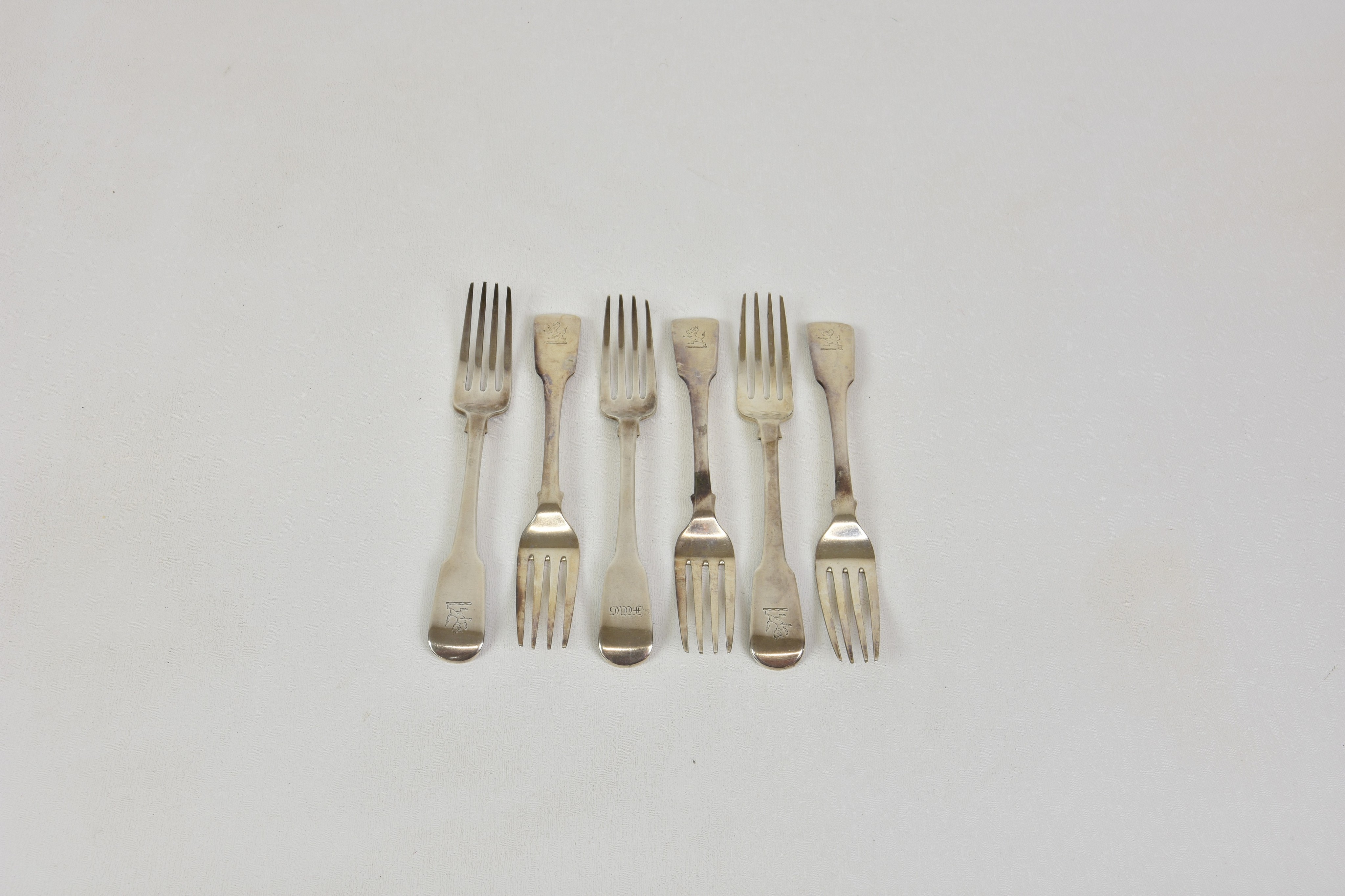 A matched set of six George IV fiddle pattern silver table forks, William Woodman, Exeter 1821,