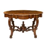 An 18th century Cape Dutch cross banded yew and burr walnut serpentine centre table, the moulded,