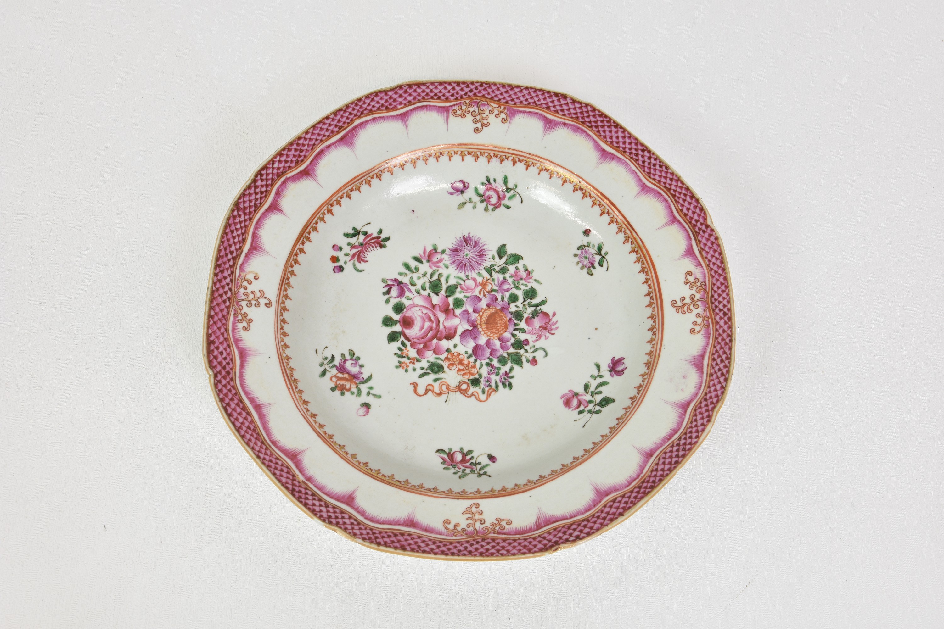 A Chinese porcelain famille rose shallow dish / soup plate, 19th century, with floral decoration