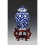 A Chinese blue and white porcelain covered vase, 20th century, ovoid with flared foot and short,