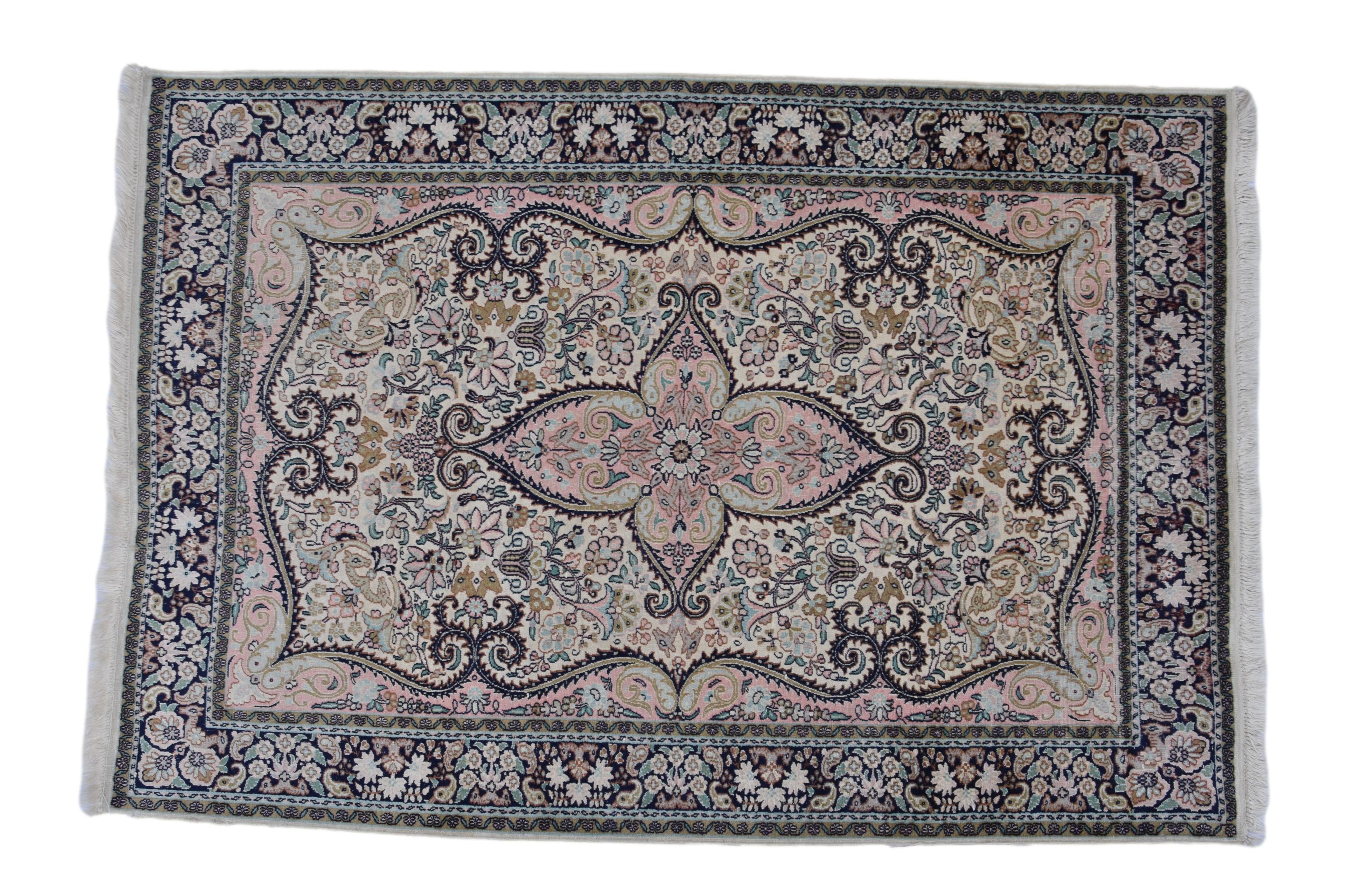 An Indian silk rug, on ivory ground, with central medallion and repeating floral, fish and animal