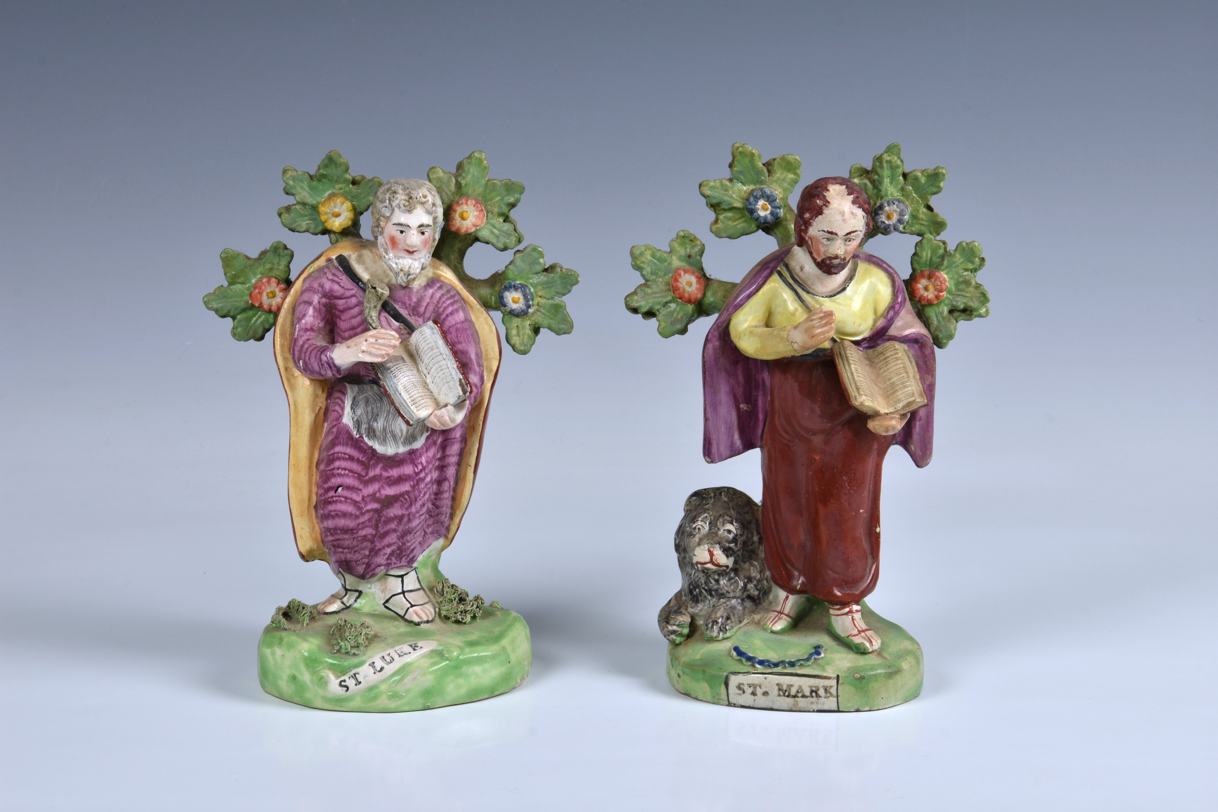 Two Staffordshire 19th century pottery figures of saints, to include 'ST.MARK', standing in front of