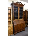 A George I style burr walnut veneered bureau bookcase, possibly a period oak bureau veneered in