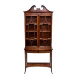 An Edwardian mahogany and marquetry glass fronted cabinet on stand