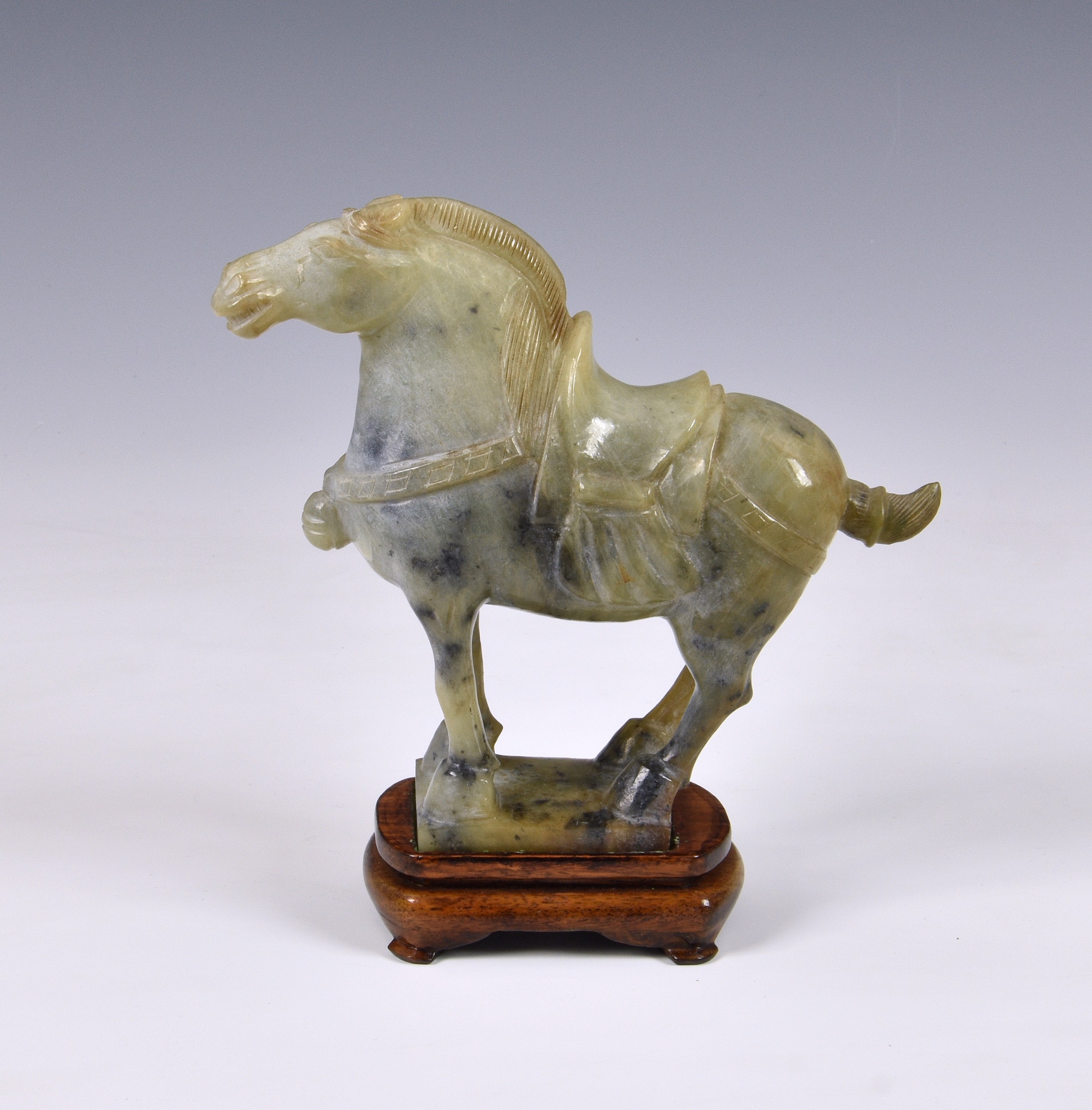 A Chinese carved green hardstone jade-style horse, modern, of typical Tang style, 7 ¾in. (19.7cm.)