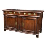 A French late 18th or early 19th century oak dresser base, with decorative brass knobs, back-