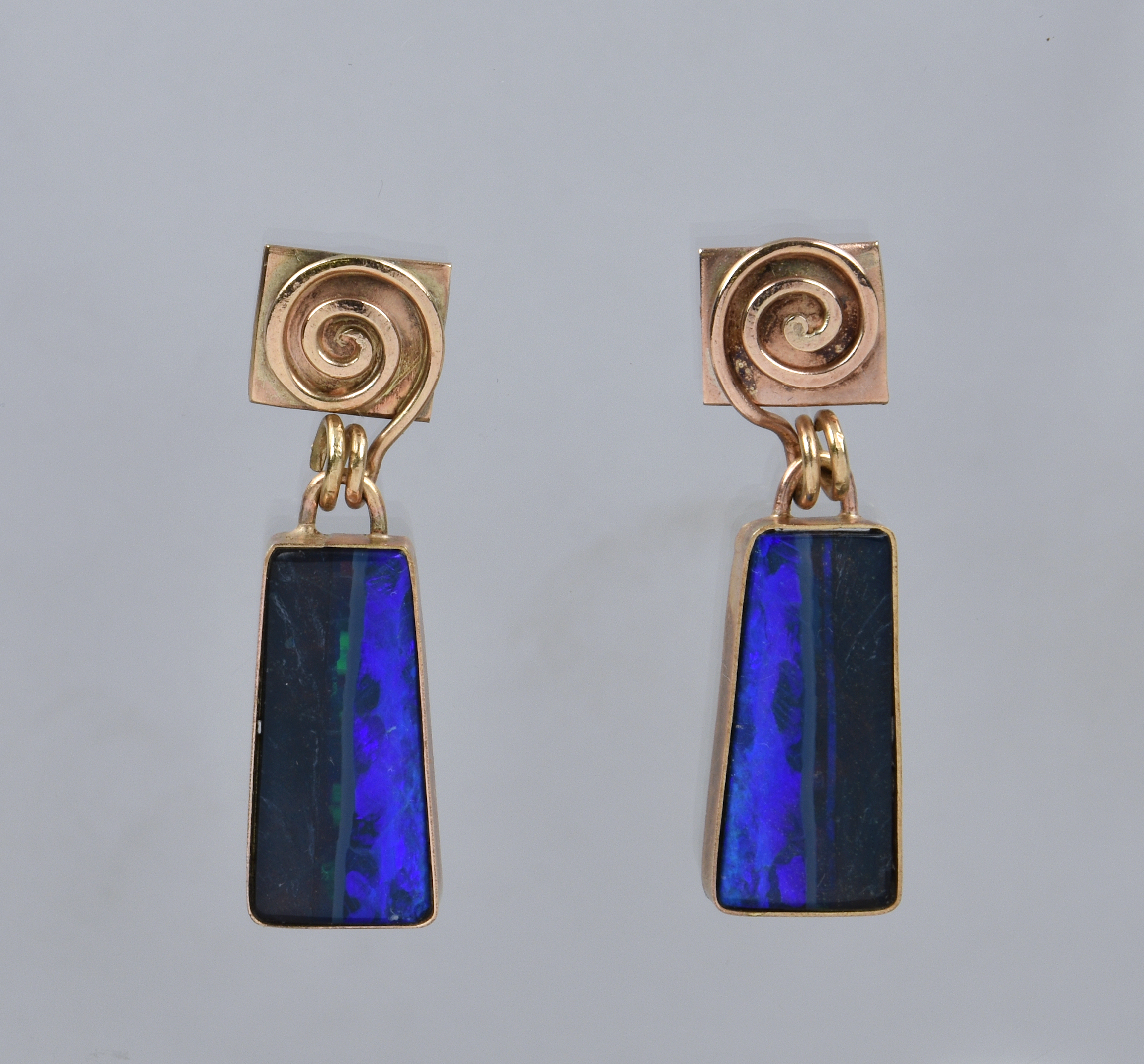 A pair of 9ct gold and opal drop earrings, unmarked, tested, the tapered, rectangular opals