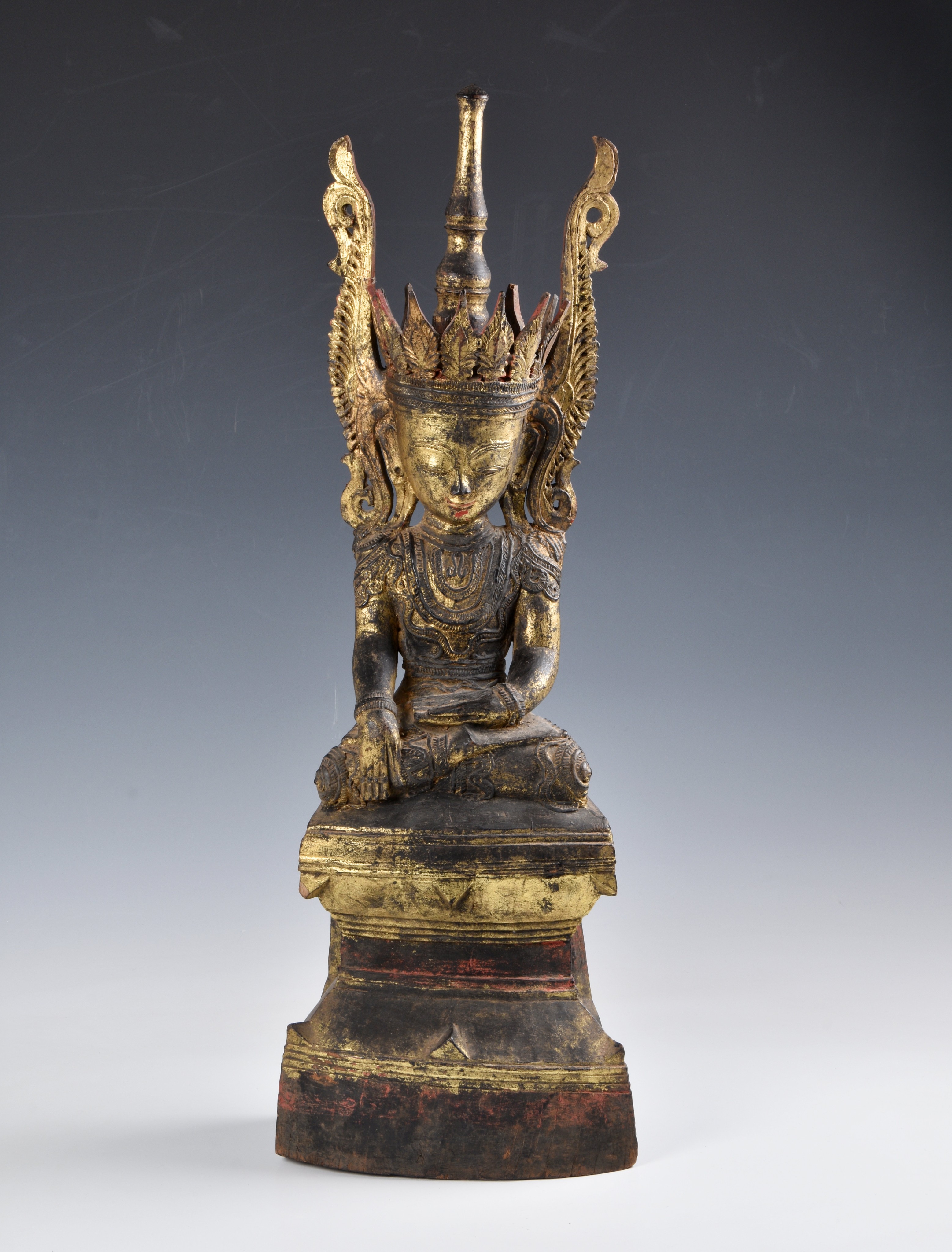 A Burmese, Shan States style carved gilt decorated Buddha, probably 19th century, the carved