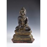 A 19th century Burmese Mandalay dry lacquer seated figure of Buddha, seated in dhyanasana on a