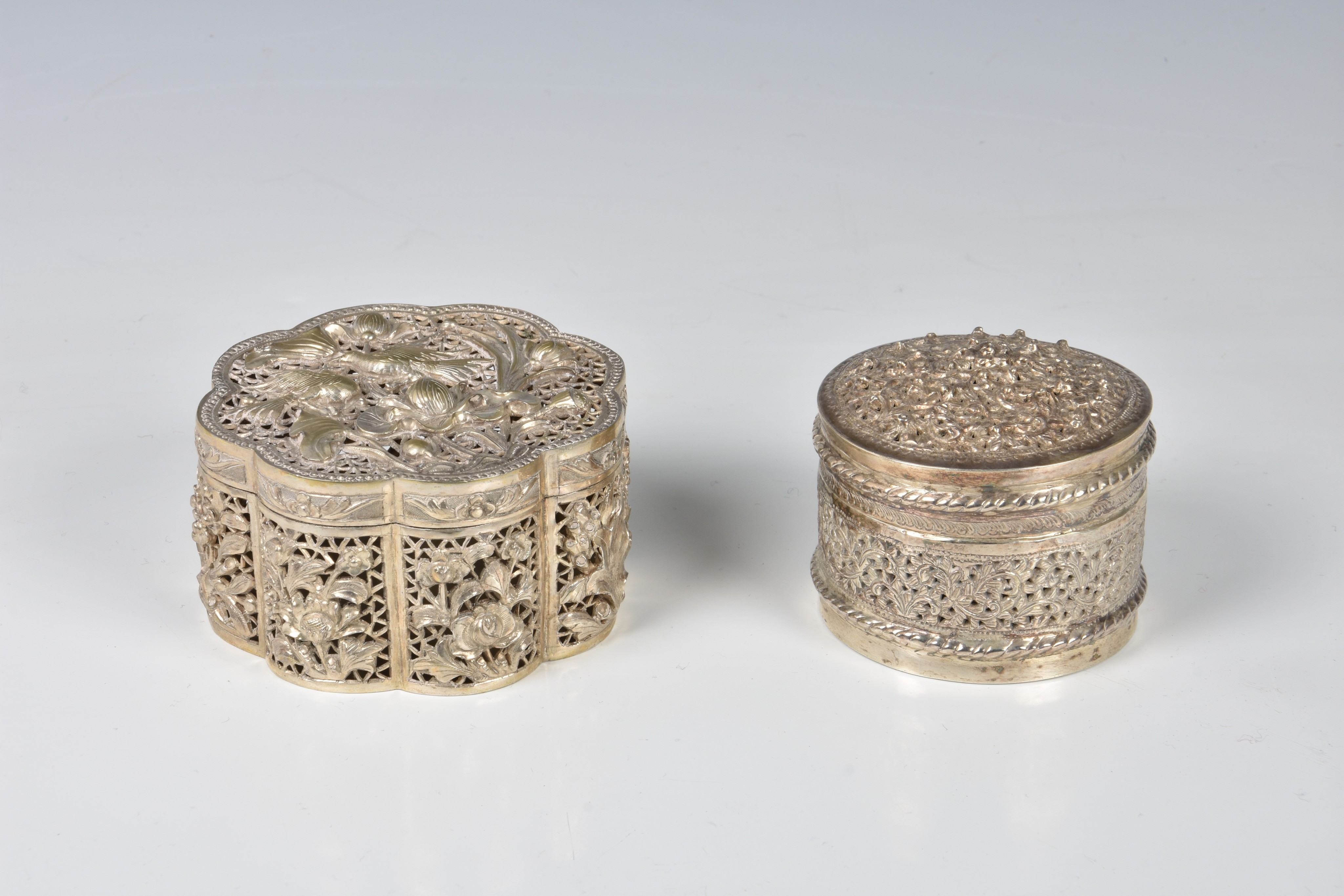 A Chinese reticulated silver lidded box, early 20th century, of eight lobed circular form, the