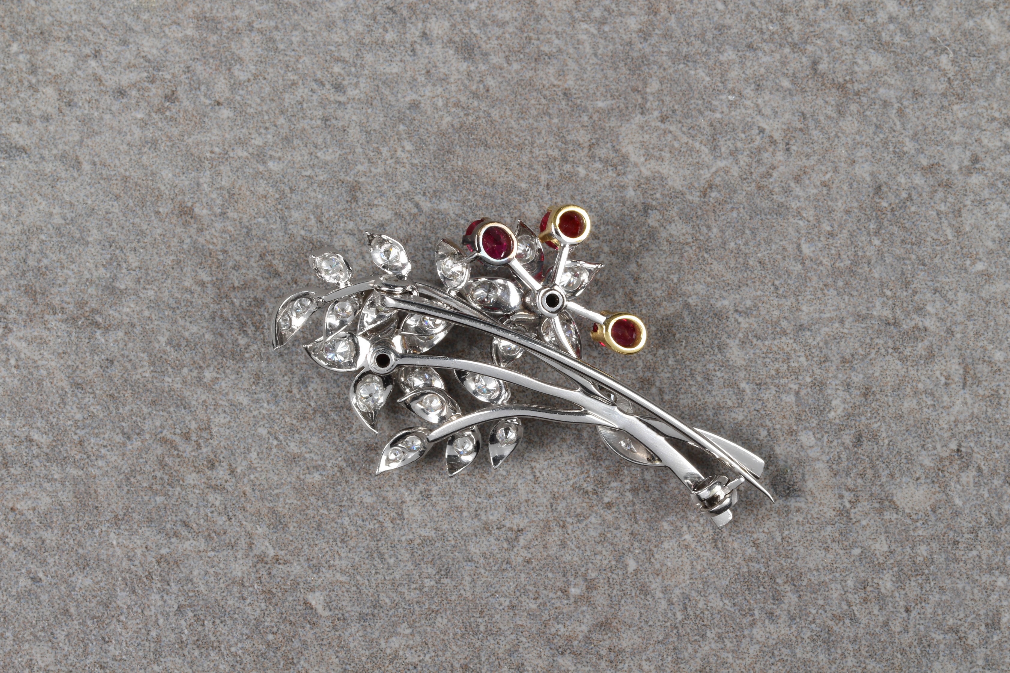 An 18ct two colour gold, ruby and diamond floral spray brooch, with five round cut rubies in - Image 2 of 2