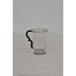 A Georgian blown glass tankard, with dark coloured handle and flared rim, pronounced pontil, 4in. (