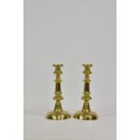 A good pair of antique round-based brass candlesticks, with knopped, tapered columns, 10½in.