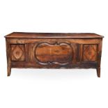 An 18th century Continental fruitwood coffer, with a three-plank lid, the front with a large central