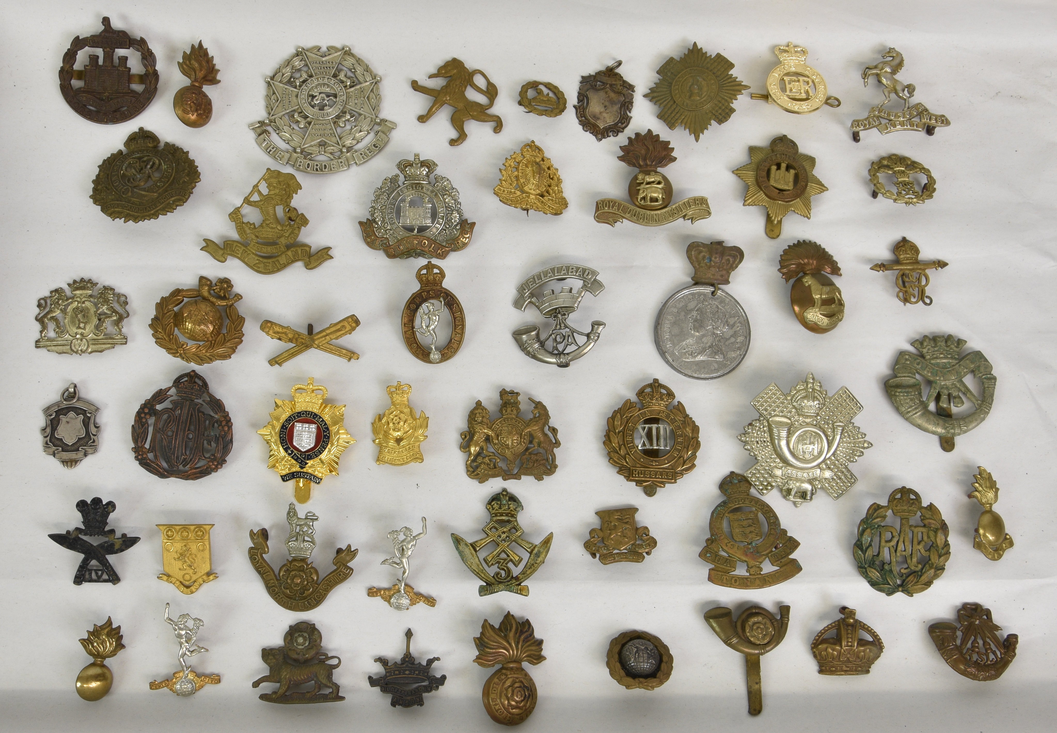 A large collection of approximately one hundred & thirty (130) various Military cap badges / patches