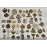 A large collection of approximately one hundred & thirty (130) various Military cap badges / patches