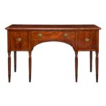 A George IV ebony strung mahogany sideboard, with a central long drawer over an arched kneehole,