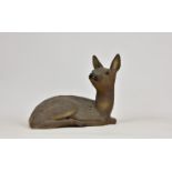 A ceramic figure of a fawn, unglazed, unmarked, 11½in. (29.2cm.) high, 15in. (38.1cm.) wide.. *