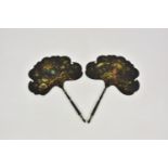 A pair of Victorian black papier-mâché face screens, painted with birds and flowers, on turned and