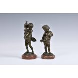 After Claude Michel Clodion (French, 1738-1814), A pair of bronze figures of cherubs, one carrying a