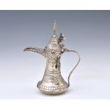 A Middle-Eastern white metal Dallah coffee pot, all over decorated with repeating stylised foliate