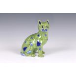 A German “Galle type” Mosanic pottery model of a seated cat, painted in lime green with naive blue