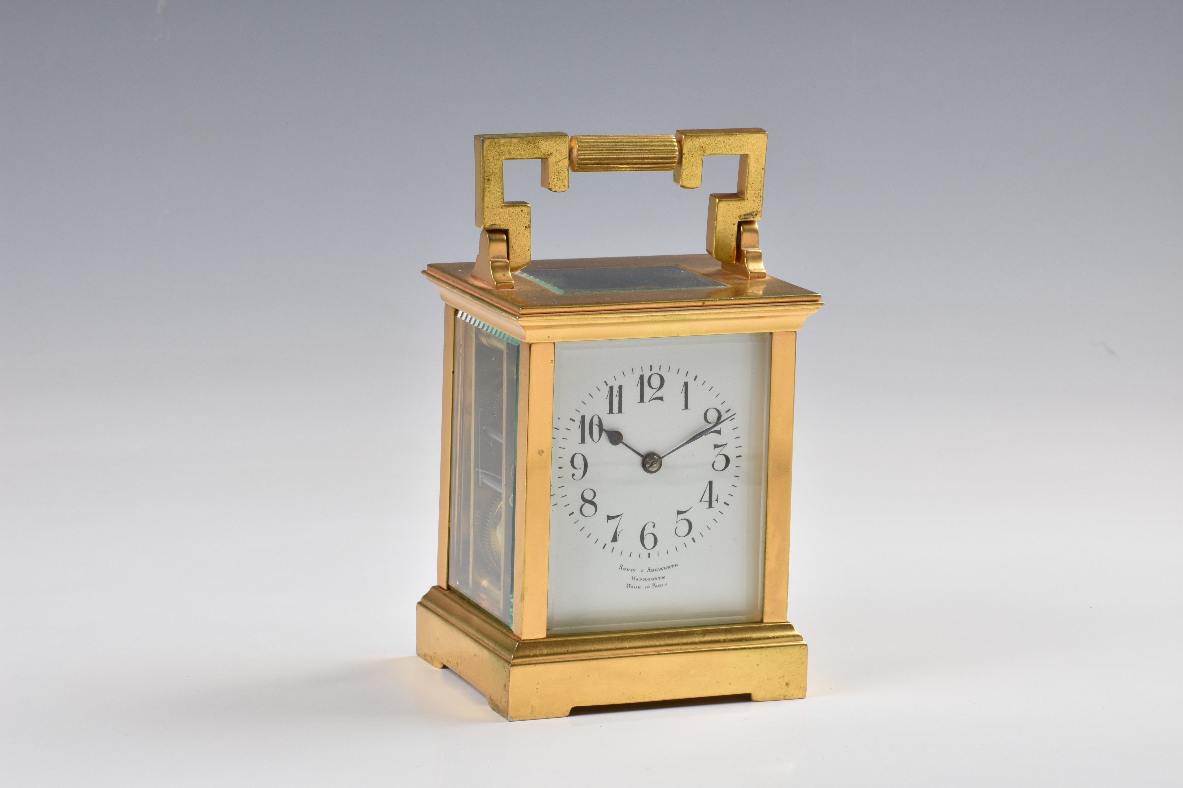 A French gilt brass carriage clock, c.1900, the white enamel Arabic dial signed 'Snow & Ashworth