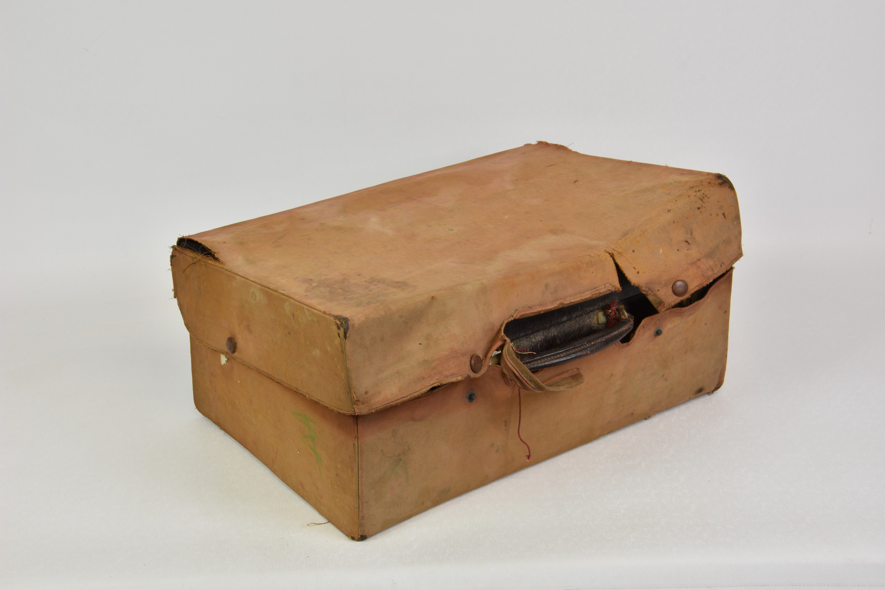 A good quality canvas covered maroon leather fitted dressing case, early 20th century, with