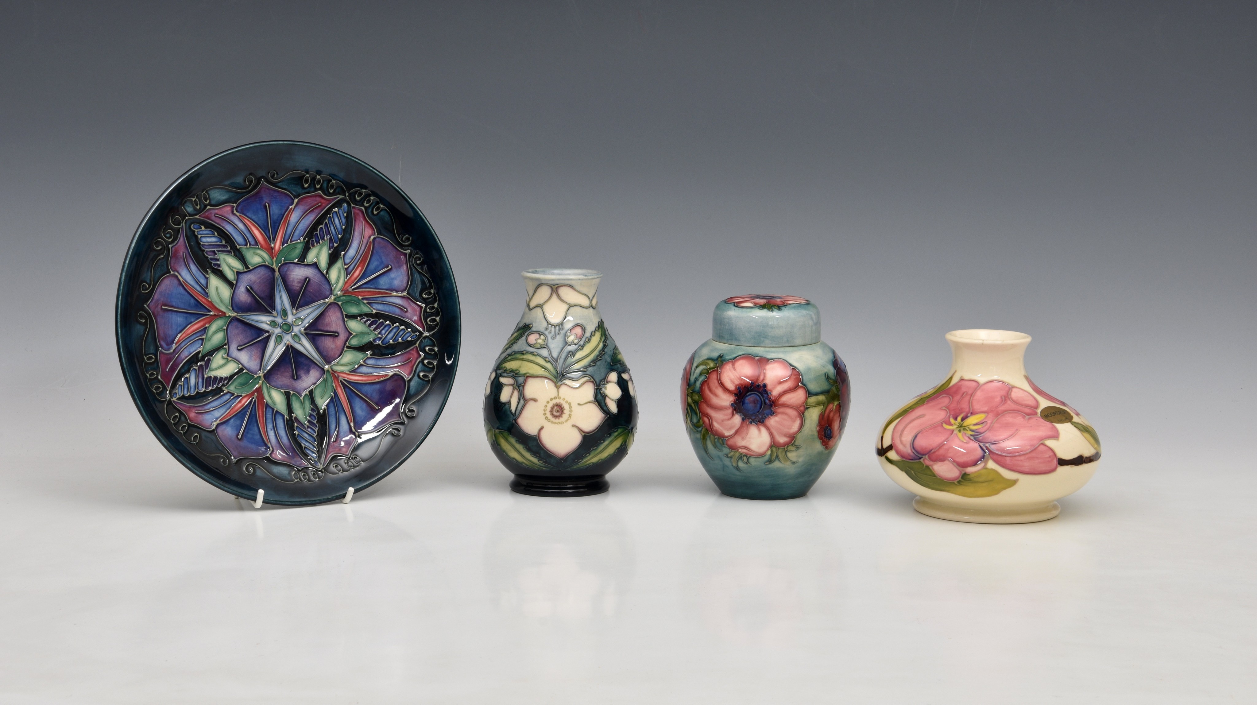 A collection of Moorcroft Pottery, to include a squat vase 'Pink Magnolia' pattern on ivory