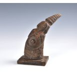 Tribal art - A carved horn figure of a dancer in an elephant mask, with brass coin button to the