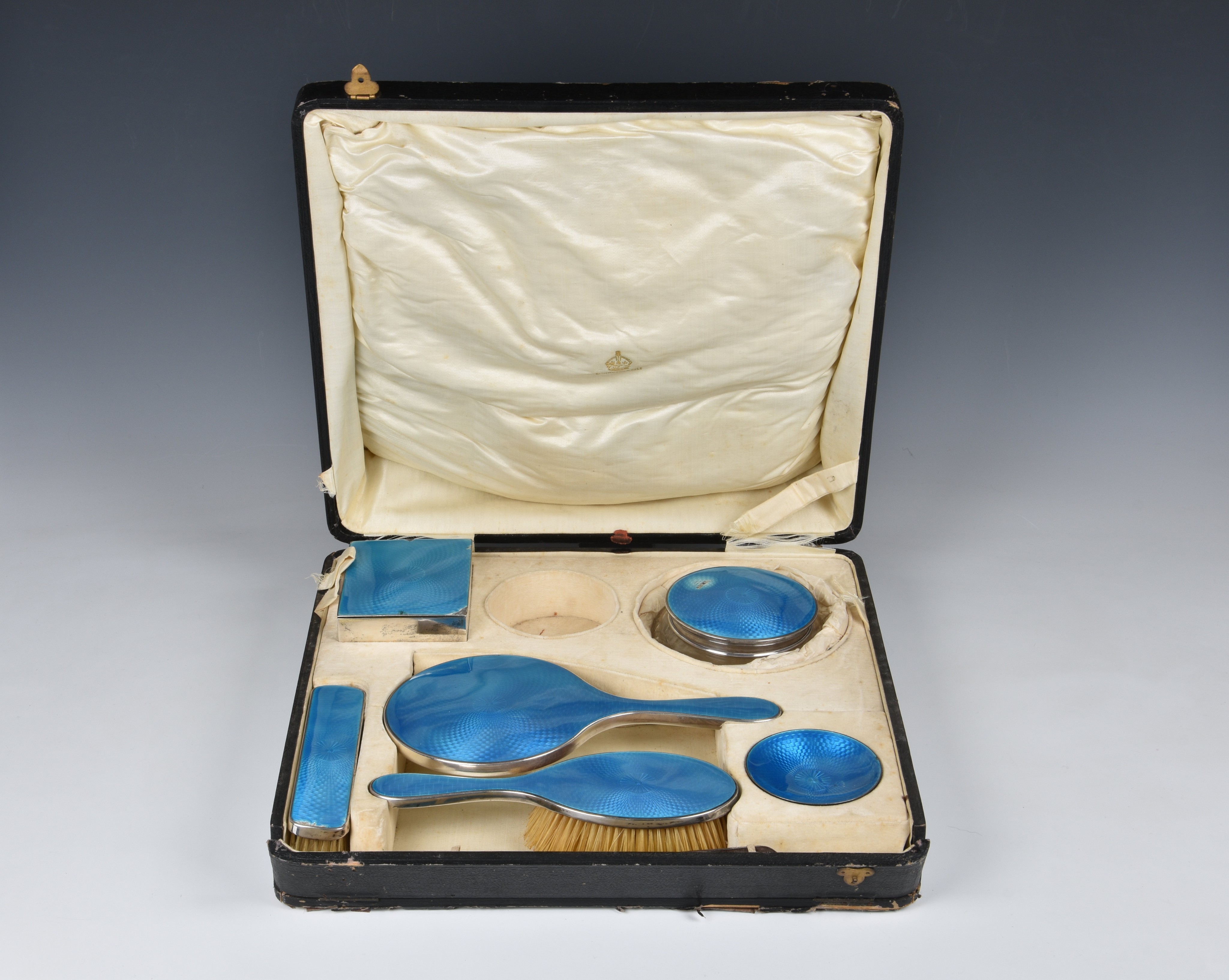 A cased George V silver and guilloche enamel dressing table set, Henry Clifford Davis, Birm. 1924,