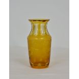 An amber cut-glass vase with flash cut flared neck, finely engraved with central cartouches, running