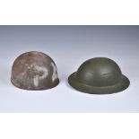 An American army steel helmet, and a British Brodie helmet. (2) Both with wear and signs of rust