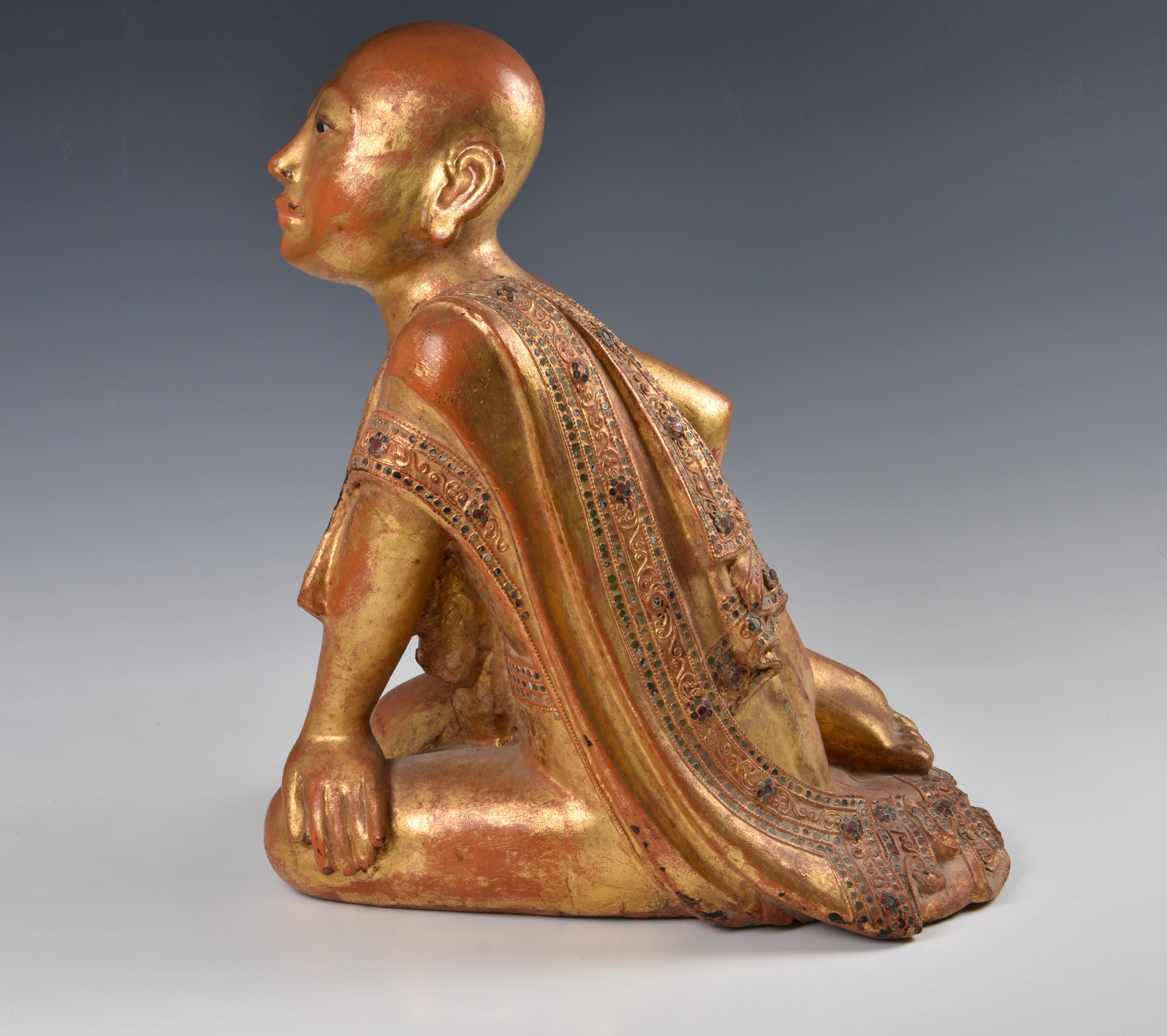 A Burmese Mandalay carved, lacquered and jewelled gilt wood figure of a seated monk, probably late - Image 8 of 9