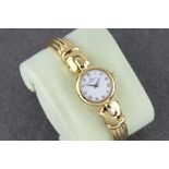 An 18ct gold ladies bangle watch by Baume & Mercier, ref. 16688.9, c.1994, the 17mm. white dial with