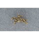 A 9ct gold galloping racehorse charm or pendant, 29mm. long..