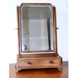 A George III mahogany box base dressing table mirror, with a single drawer to the base, on ogee