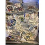 STAMPS FOR CHARITY Shoe box with thousands of loose off paper sorted by country being sold on