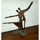 A bronze abstract group of a couple dancing, in a simplified stick like form, height 40cm.