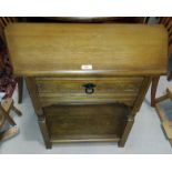 A reproduction oak , canted hall table with drawer and undershelf; a late 19th/early 20th century