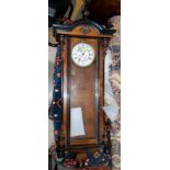A 19th century Vienna wallclock with turned finials and mounts and a double weight driven striking