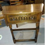 An oak hall table with canted front and frieze drawer