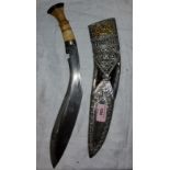 A ceremonial bone handled kukri with ornate worked white metal and yellow metal scabbard, blade