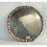 A hallmarked silver  circular salver with raised wavy border, on 4 paw feet, diameter 35 cm,