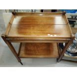 A 1920's stained wood trolley with folding top, 65 cm; a rush seat stool