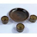 BERNARD LEACH, 3 brown stoneware egg cups and circular stand, impressed mark