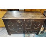 An 18th century mule chest bearing date "1723" with hinged top, geometric moulded decoration and 2
