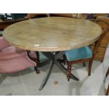 A stained wood period style dining table with circular top, on 4 splay feet