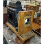 An antique Japaned lantern projector with added wooden Houghtons enlarger.