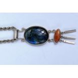 A white metal pendant, stamped 1925, set with oval labradorite cabochon stone and lower brown